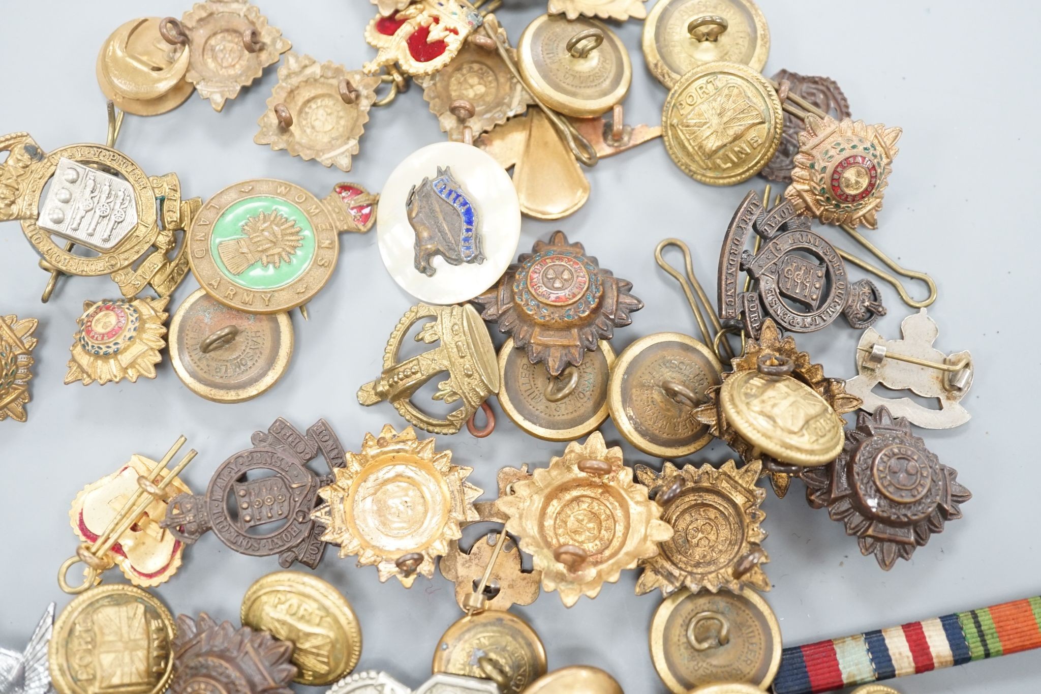 A quantity of cap badges, buttons and badges